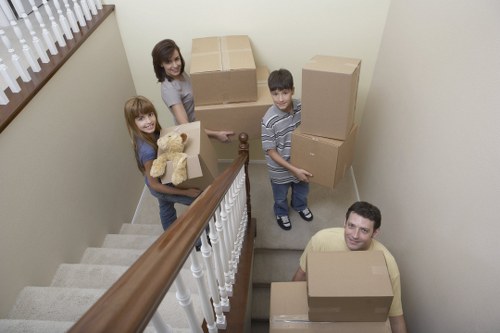 Local movers handling boxes and furniture for a student move in West London
